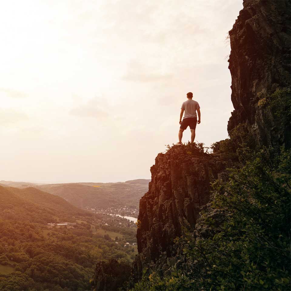 man on top of a mountain